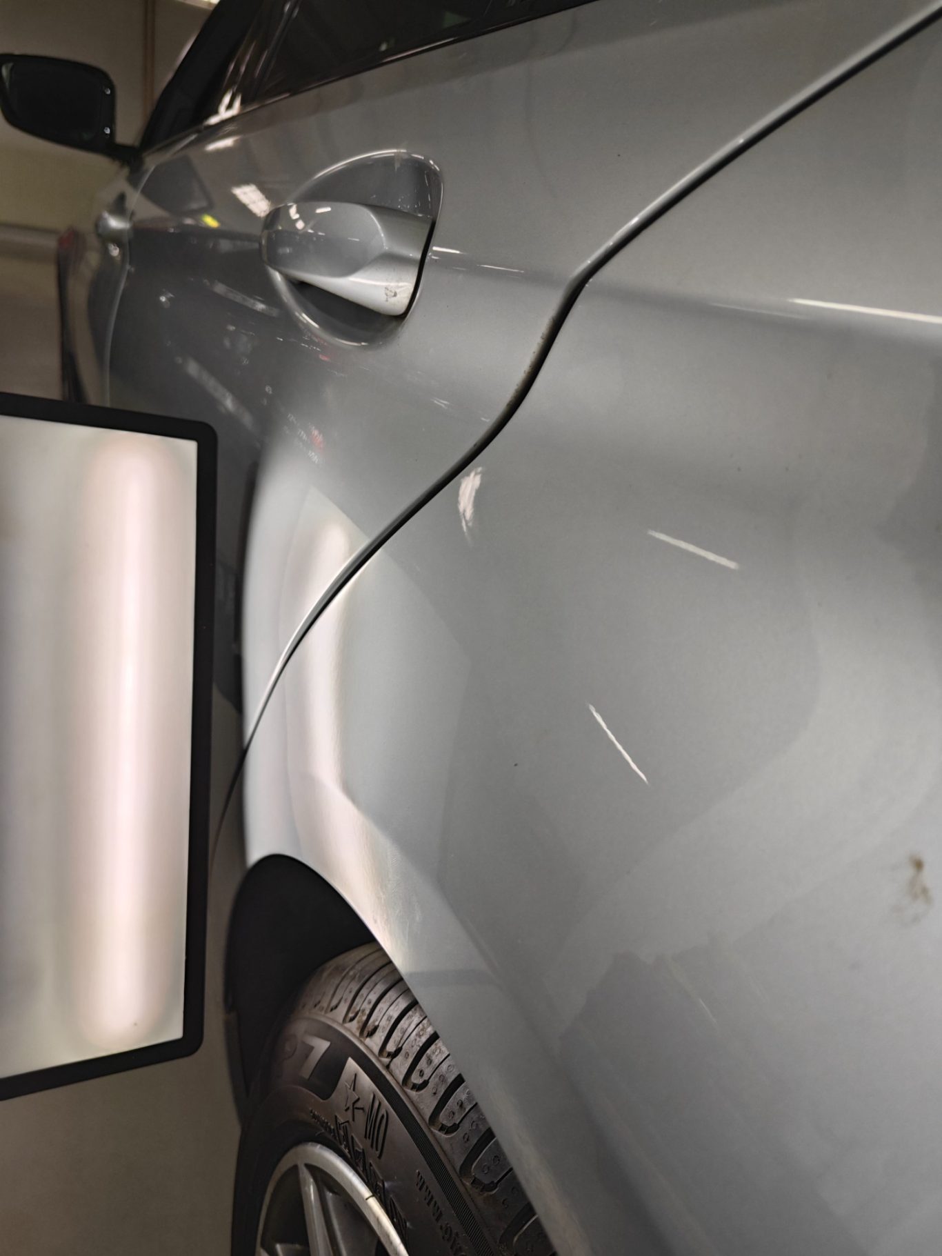 BMW 5er Seitenwand nachher Die Seite eines Autos mit einer Kante und einem Reifen im Vordergrund.